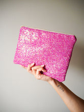 This hot pink glitter clutch bag has a zip fastening into the main compartment, where you'll find a floral print cotton lining.
