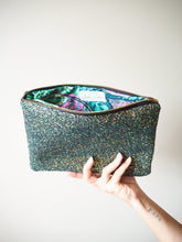 The inside of this black glitter clutch bag is lined with 100% cotton with a floral and paisley print to add a quirky aesthetic.