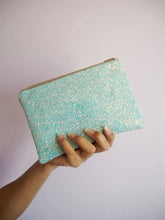 This pastel blue glitter makeup bag is handmade and can be used as a sparkly clutch bag during a special occasion.