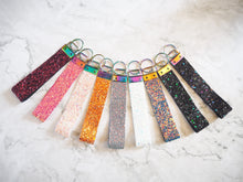 This Handmade Glitter Wristlet Keyring comes in many colours and is finished with a rainbow split ring to hold multiple keys.