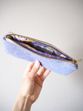 This sparkly glasses case is made out of lilac glitter with a rainbow sparkle and a matching purple cotton lining.