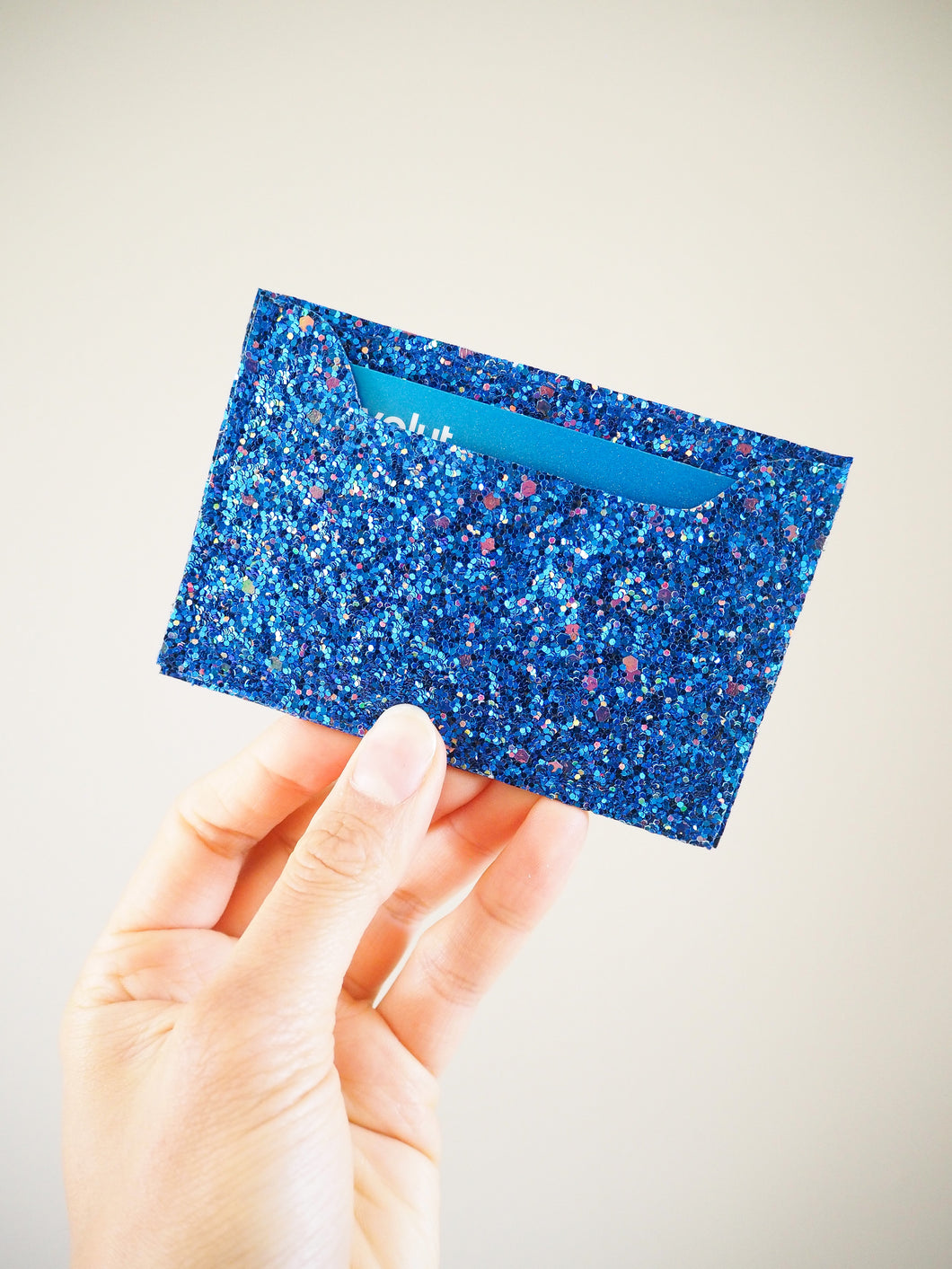 This royal blue glitter card holder can hold a few credit cards or travel cards inside the single card compartment.