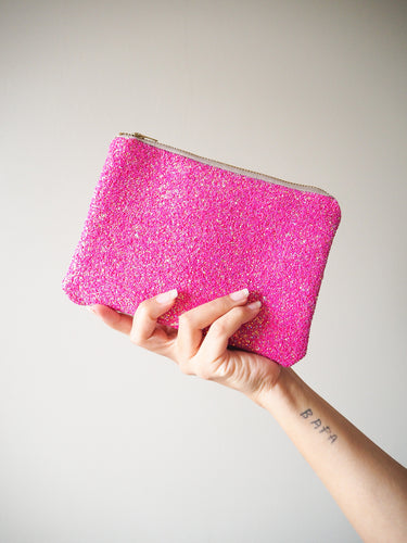 This hot pink glitter makeup bag is handmade in limited quantities and is great for using as a small clutch bag.