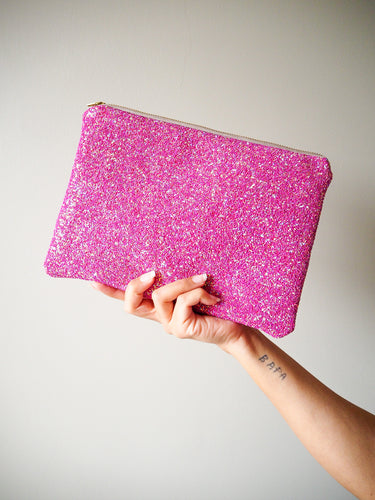 This handmade hot pink glitter clutch is a fun accessory that can brighten up a colourful outfit.