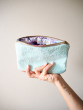 This handmade lagoon blue glitter makeup bag has a cotton lining that is made from 100% cotton with a gorgeous floral print.
