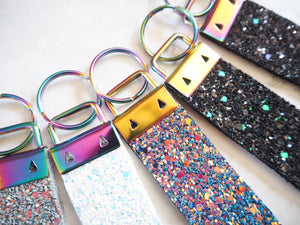 Keep your keys together safely with this handmade glitter wristlet strap keyring that allows you to hook onto your bag or hang them up.