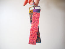 This pink glitter wristlet strap is great for hanging onto your car or house keys and allows the glitter to catch the light.